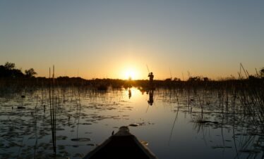 Mokoro on sunset by Xplorer's Edge Tours and Safaris